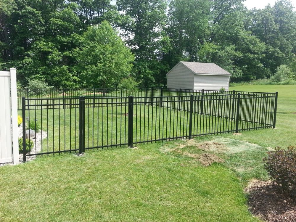 Black aluminum fence around a yard