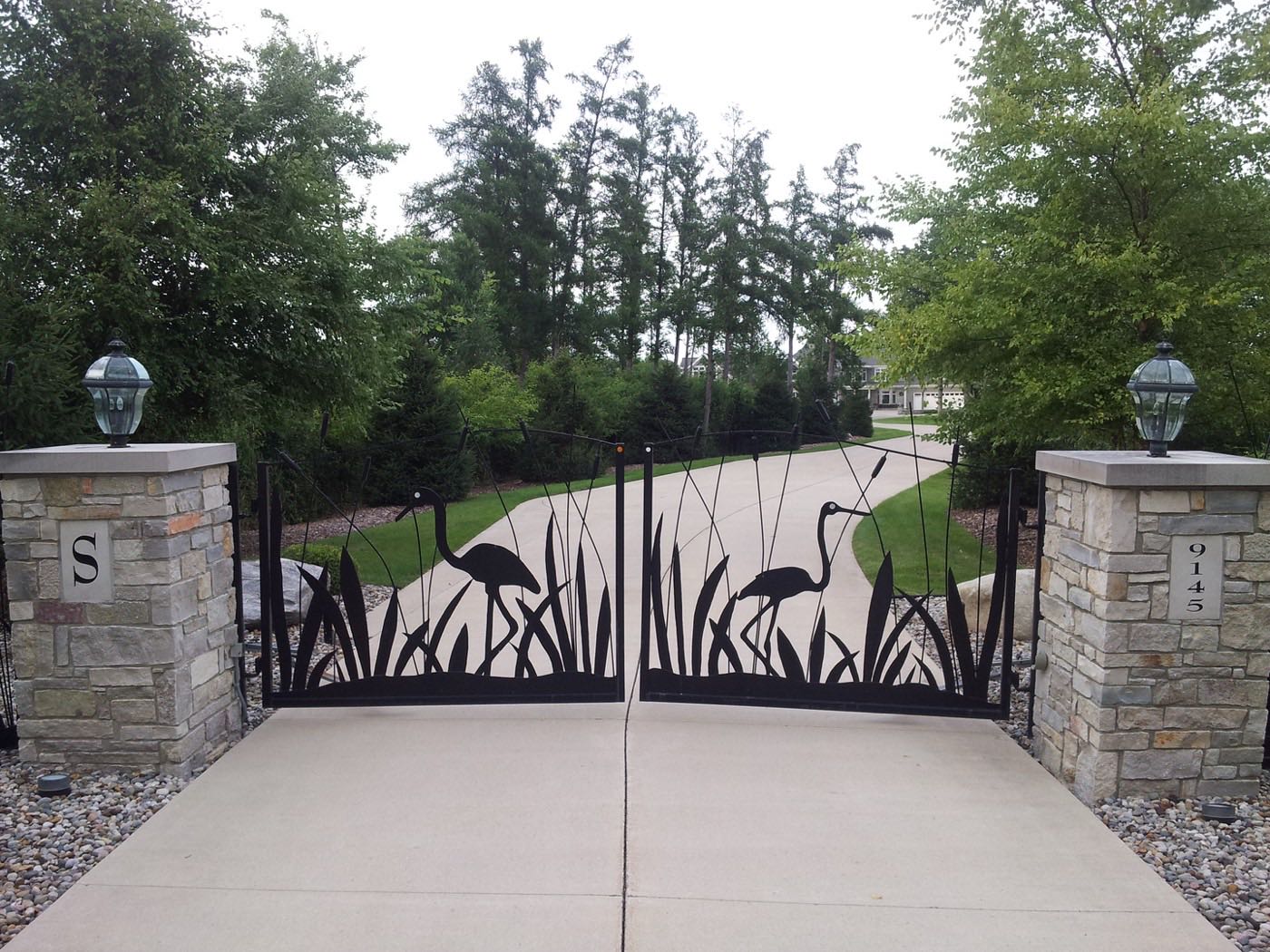 Custom driveway gate with heron and cattail silhouettes