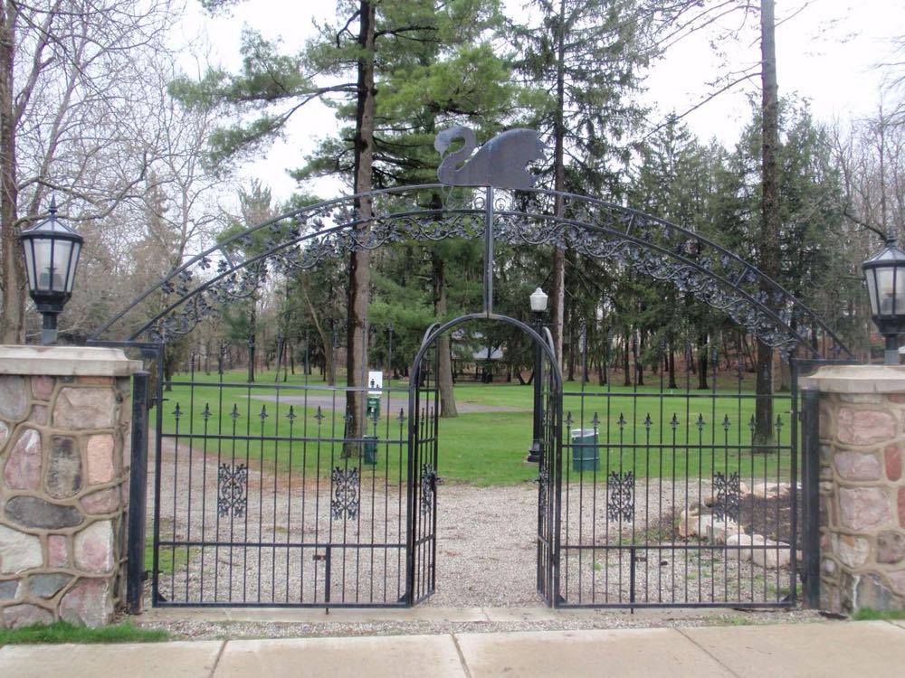 Arched wrought iron entry gates with lanterns