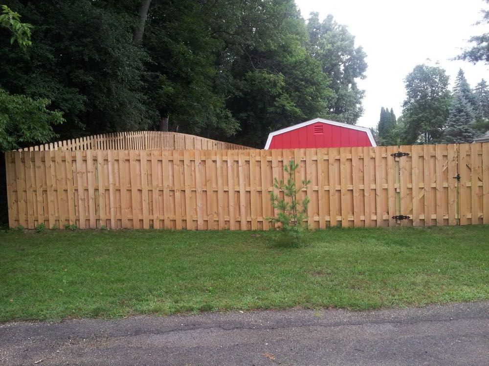 Scalloped wood privacy fence