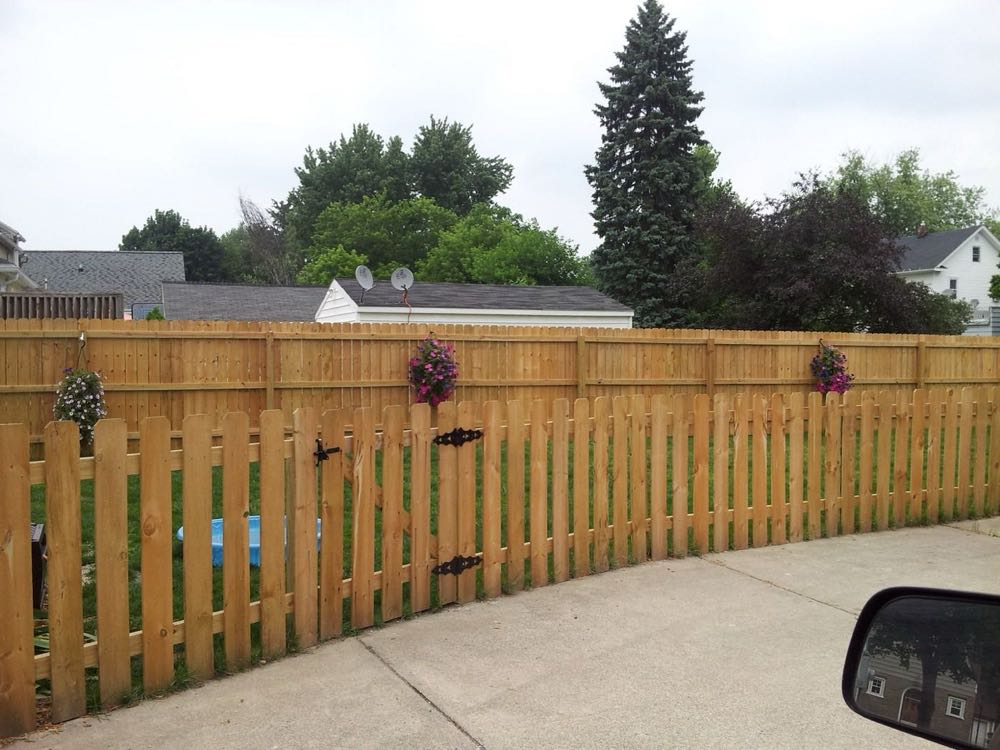 Wood picket fence along a driveway